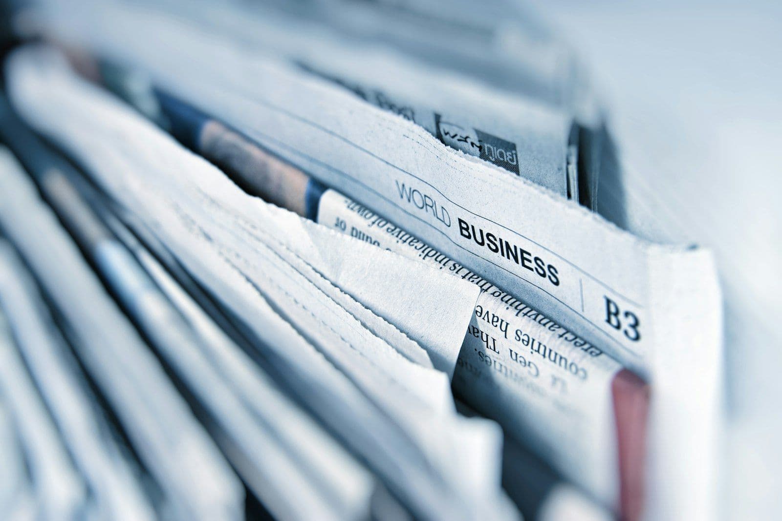Stack of business newspapers — El Cronista coverage on Argentina's first social network and local tech ecosystem history