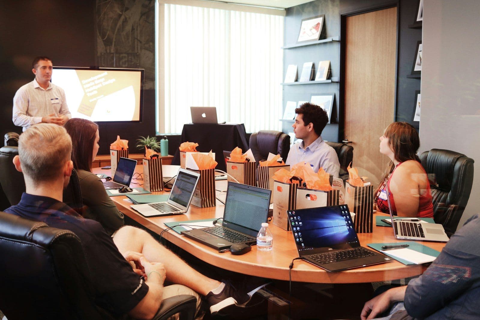 HR team in a strategic meeting with laptops discussing return-to-office and employee experience challenges